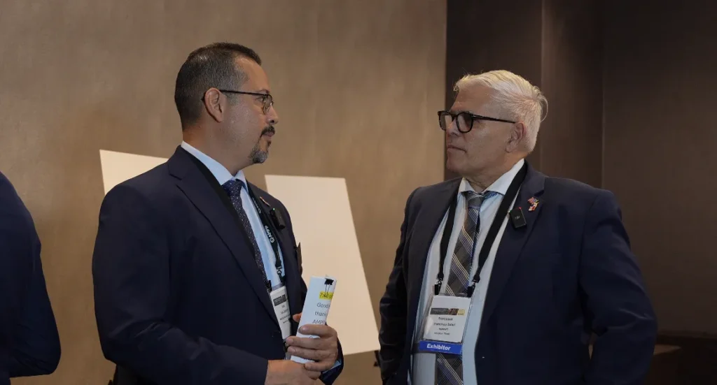 Francesco Solari speaking with Juan Caballero during LatinCORR 2025