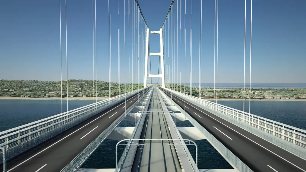 Puente sobre el estrecho de Mesina, con carriles para vehículos y vías férreas, bajo un cielo despejado y con vistas a la costa de Sicilia y la península italiana.