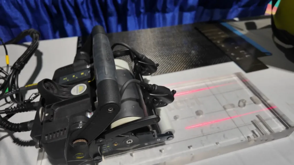 Sonatest WheelProbe 2 ultrasonic transducer performing inspection on test block with simulated defects.